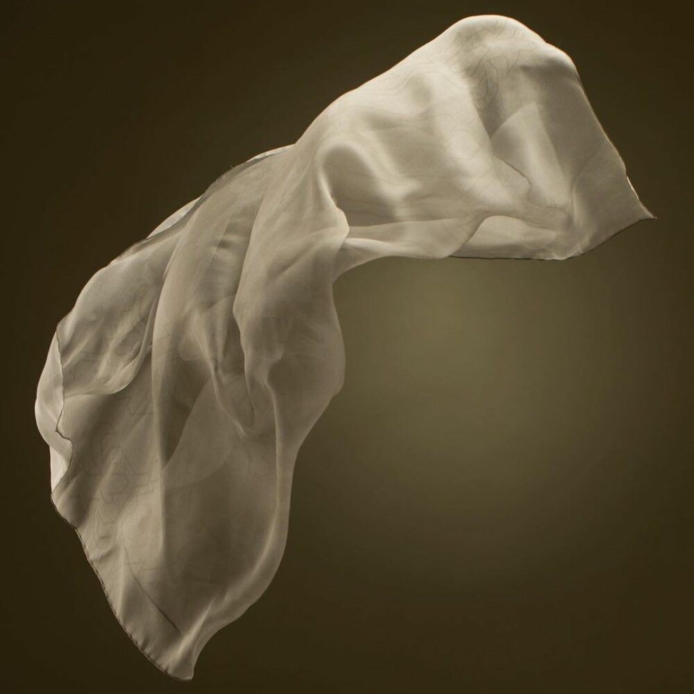 flowing sheer silk fabric on dark background