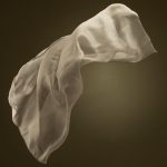 flowing sheer silk fabric on dark background